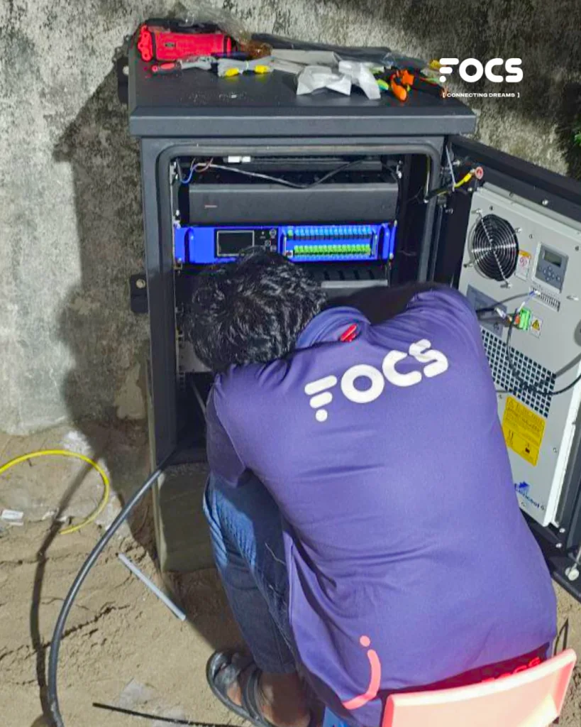 FOCS technician working on an island fiber network cabinet